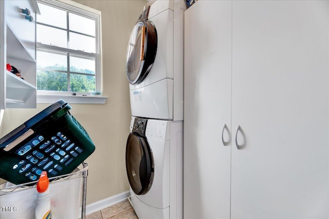 3217 Enchanting Way, Raleigh, NC 27616 - laundry area featuring stacked washing machine and dryer and light tile patterned flooring