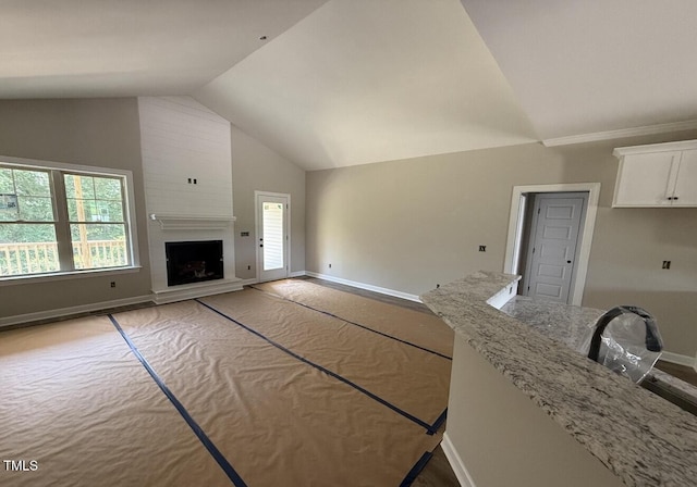 2760 Rains Mill Rd, Princeton, NC 27569 - unfurnished living room featuring high vaulted ceiling and a large fireplace