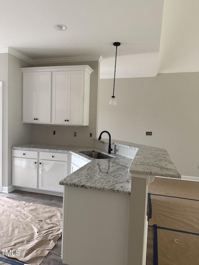 2760 Rains Mill Rd, Princeton, NC 27569 - kitchen featuring white cabinetry, a peninsula, ornamental molding, light stone counters, and hanging light fixtures