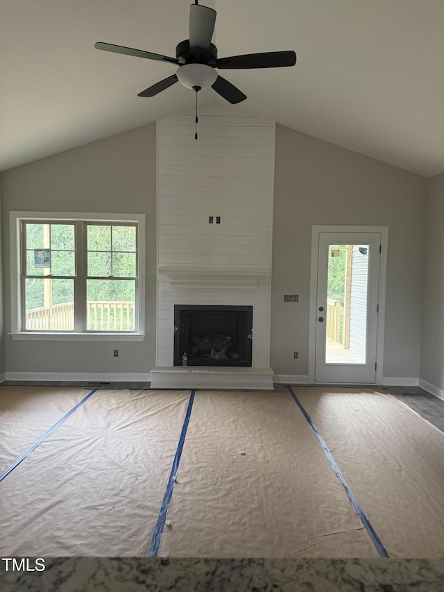 2760 Rains Mill Rd, Princeton, NC 27569 - unfurnished living room featuring lofted ceiling, a large fireplace, and a ceiling fan
