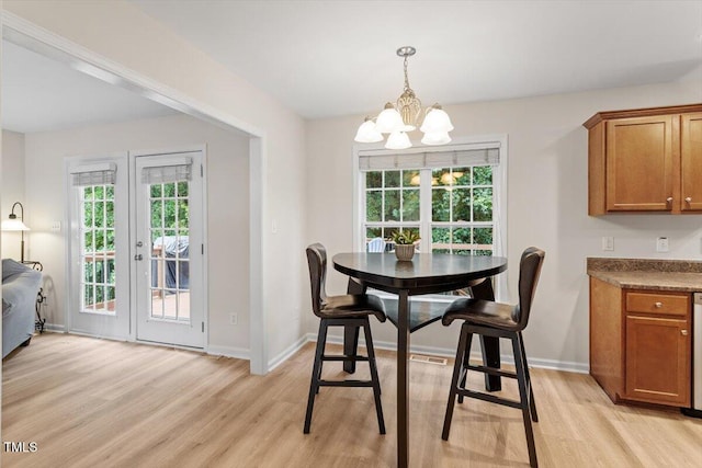 161 Jacob St, Holly Springs, NC 27540 - dining space featuring a chandelier, light wood-type flooring, and healthy amount of natural light