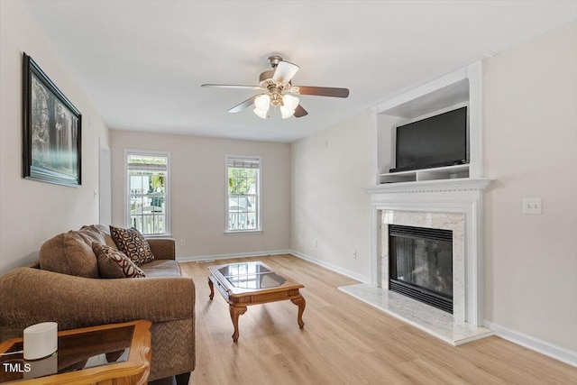 161 Jacob St, Holly Springs, NC 27540 - living area featuring light wood-style floors, a ceiling fan, and a fireplace
