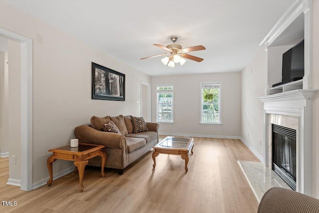161 Jacob St, Holly Springs, NC 27540 - living room featuring light wood finished floors, a ceiling fan, and a high end fireplace
