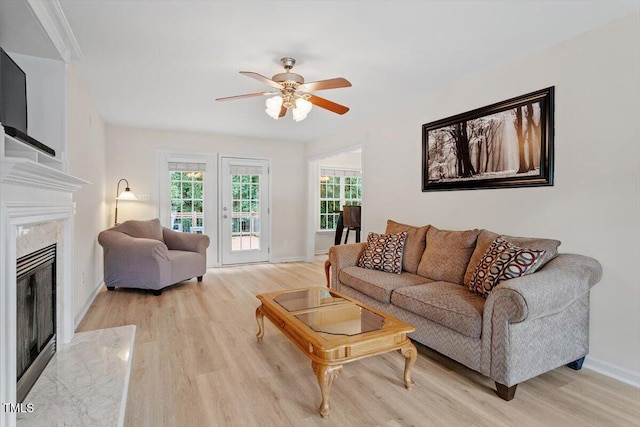 161 Jacob St, Holly Springs, NC 27540 - living area with light wood-type flooring, ceiling fan, and a premium fireplace