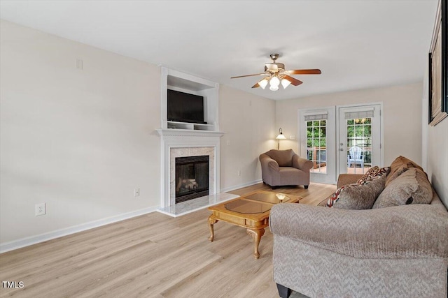 161 Jacob St, Holly Springs, NC 27540 - living area featuring light wood-type flooring, ceiling fan, and a premium fireplace
