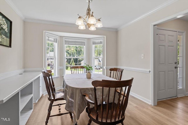 161 Jacob St, Holly Springs, NC 27540 - dining space featuring light wood-style floors, a chandelier, and crown molding