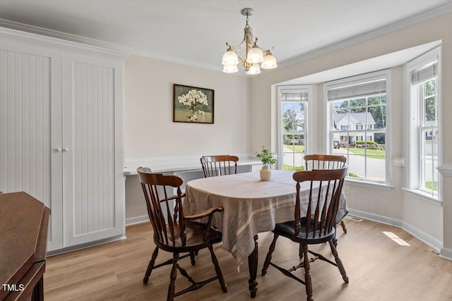 161 Jacob St, Holly Springs, NC 27540 - dining area featuring light wood-type flooring, crown molding, healthy amount of natural light, and a chandelier