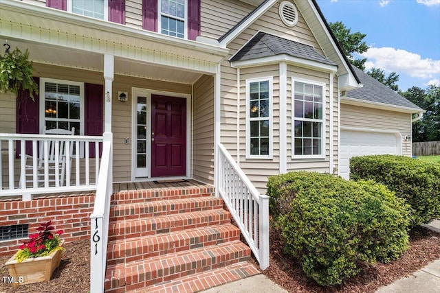 161 Jacob St, Holly Springs, NC 27540 - doorway to property featuring an attached garage and roof with shingles