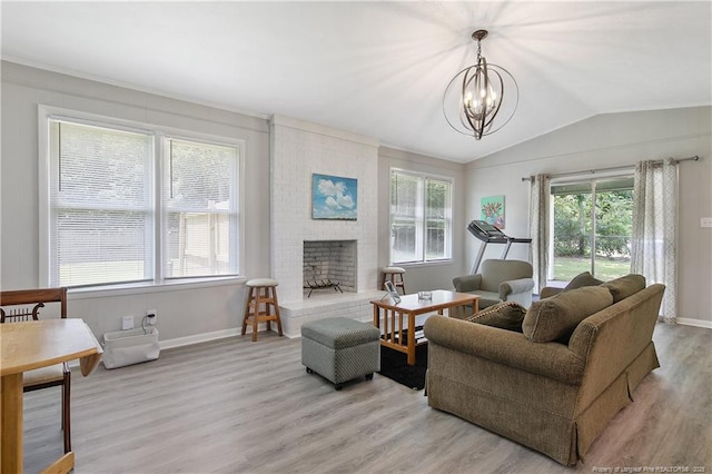 6501 Senator Dr, Fayetteville, NC 28304 - living area with light wood-type flooring, lofted ceiling, a chandelier, and a fireplace