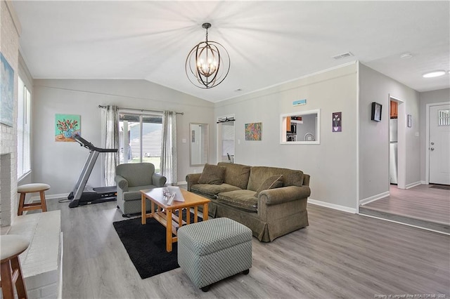 6501 Senator Dr, Fayetteville, NC 28304 - living room featuring wood finished floors, a chandelier, and lofted ceiling