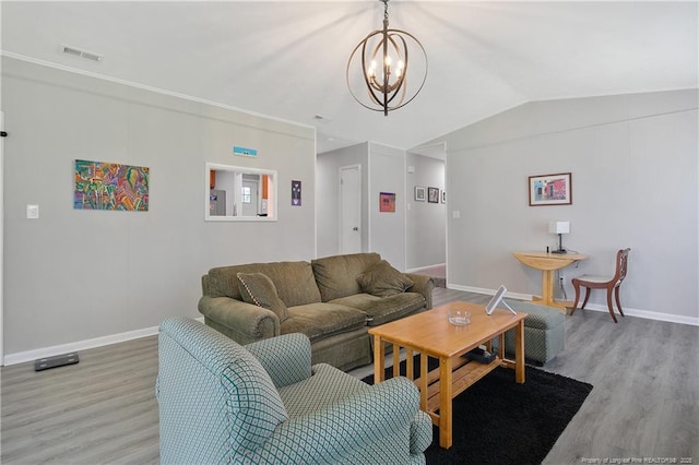 6501 Senator Dr, Fayetteville, NC 28304 - living room featuring wood finished floors, a chandelier, and lofted ceiling