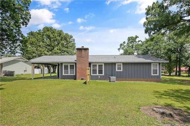 6501 Senator Dr, Fayetteville, NC 28304 - back of property featuring board and batten siding, a chimney, a yard, and an attached carport