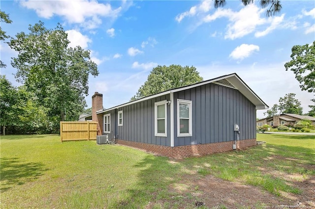 6501 Senator Dr, Fayetteville, NC 28304 - view of side of property with board and batten siding and a chimney