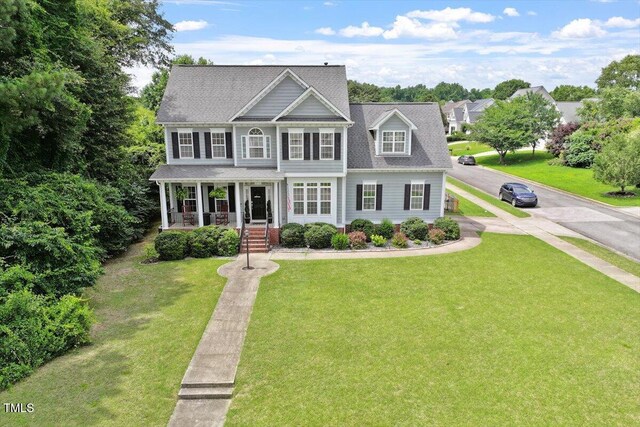 1505 Mclaurin Ln, Fuquay Varina, NC 27526 - view of front of house featuring a front lawn, a porch, and a shingled roof
