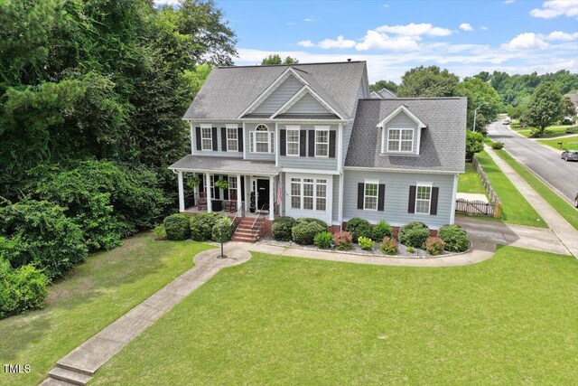 1505 Mclaurin Ln, Fuquay Varina, NC 27526 - view of front facade with a porch, a front yard, and roof with shingles