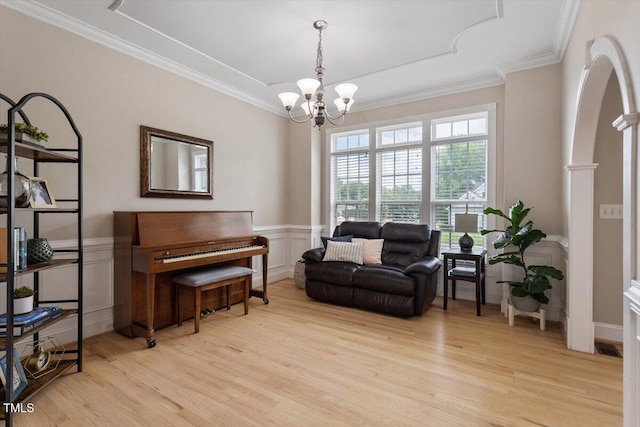 1505 Mclaurin Ln, Fuquay Varina, NC 27526 - living area with light wood-type flooring, a chandelier, crown molding, a decorative wall, and a wainscoted wall
