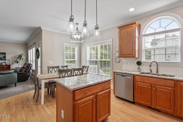 1505 Mclaurin Ln, Fuquay Varina, NC 27526 - kitchen featuring stainless steel dishwasher, healthy amount of natural light, light wood-style floors, light stone counters, and ornamental molding