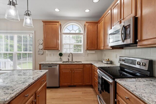 1505 Mclaurin Ln, Fuquay Varina, NC 27526 - kitchen featuring stainless steel appliances, light wood-type flooring, ornamental molding, light stone counters, and recessed lighting