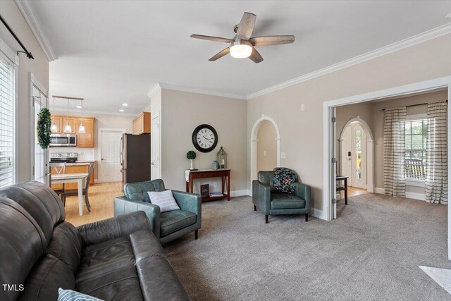 1505 Mclaurin Ln, Fuquay Varina, NC 27526 - living room featuring ceiling fan, ornamental molding, recessed lighting, light colored carpet, and arched walkways