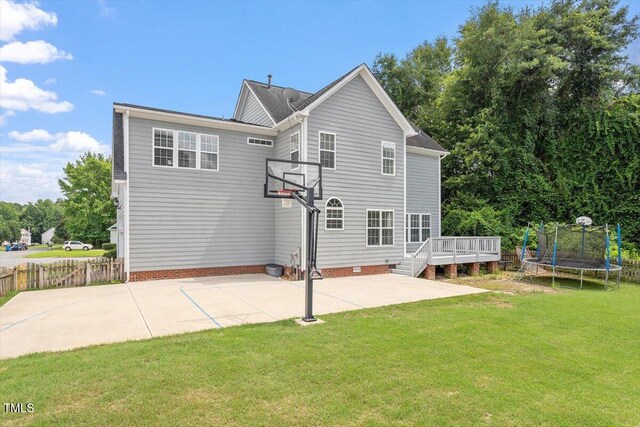 1505 Mclaurin Ln, Fuquay Varina, NC 27526 - rear view of property featuring a trampoline, a wooden deck, and a patio