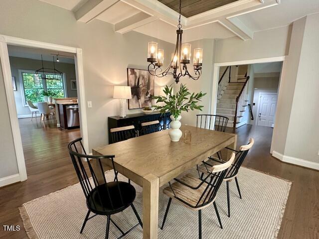 1113 Bexley Hills Bnd, Apex, NC 27502 - dining room with dark wood-type flooring, a chandelier, stairs, and beam ceiling