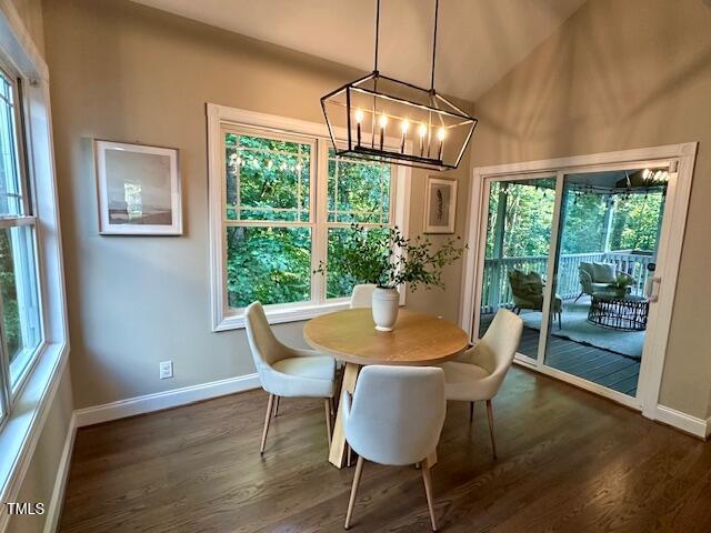 1113 Bexley Hills Bnd, Apex, NC 27502 - dining space with a chandelier, dark wood-type flooring, healthy amount of natural light, and lofted ceiling