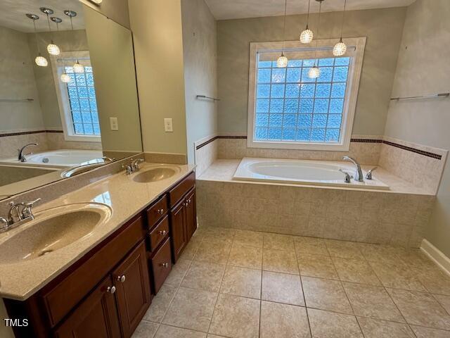 1113 Bexley Hills Bnd, Apex, NC 27502 - bathroom with a bath, tile patterned floors, and double vanity