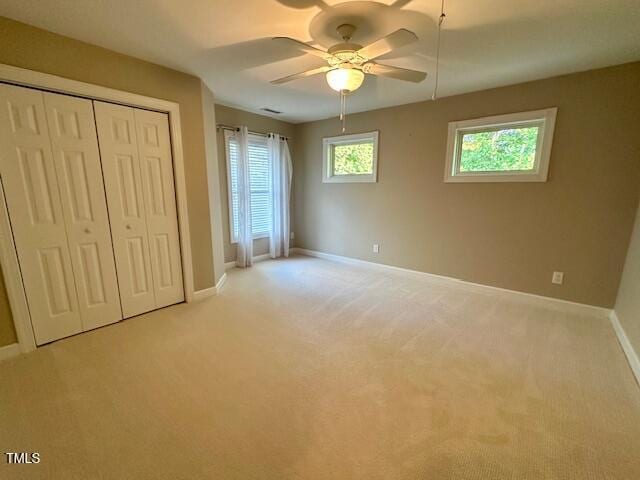 1113 Bexley Hills Bnd, Apex, NC 27502 - unfurnished bedroom with light carpet, a closet, and a ceiling fan