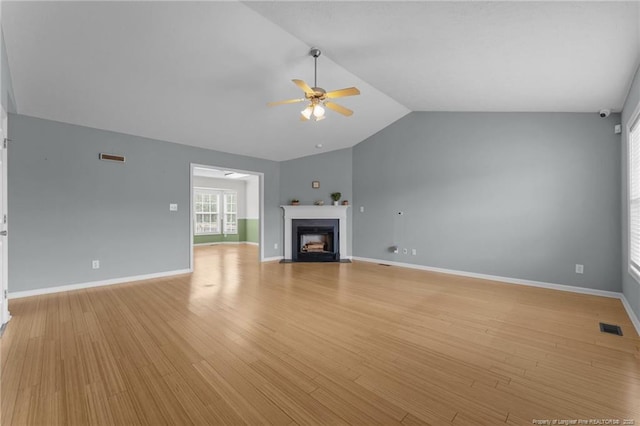 159 Falling Leaf Dr, Raeford, NC 28376 - unfurnished living room with a ceiling fan, lofted ceiling, a fireplace with flush hearth, and light wood finished floors
