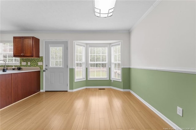 159 Falling Leaf Dr, Raeford, NC 28376 - unfurnished dining area with light wood finished floors and ornamental molding