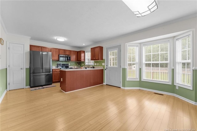 159 Falling Leaf Dr, Raeford, NC 28376 - kitchen with appliances with stainless steel finishes, light countertops, tasteful backsplash, a peninsula, and crown molding