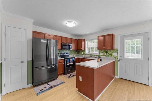 159 Falling Leaf Dr, Raeford, NC 28376 - kitchen featuring appliances with stainless steel finishes, a peninsula, light wood finished floors, backsplash, and crown molding