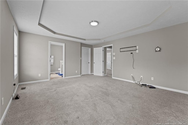 159 Falling Leaf Dr, Raeford, NC 28376 - unfurnished bedroom featuring a raised ceiling, carpet, and multiple windows
