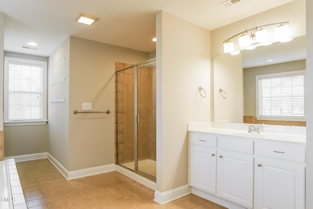 165 Sutherland Dr, Franklinton, NC 27525 - bathroom featuring a stall shower, tile patterned floors, vanity, plenty of natural light, and recessed lighting