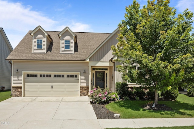 80 Scarlet Bell Dr, Youngsville, NC 27596 - view of front of home with a front lawn, a shingled roof, concrete driveway, stone siding, and an attached garage