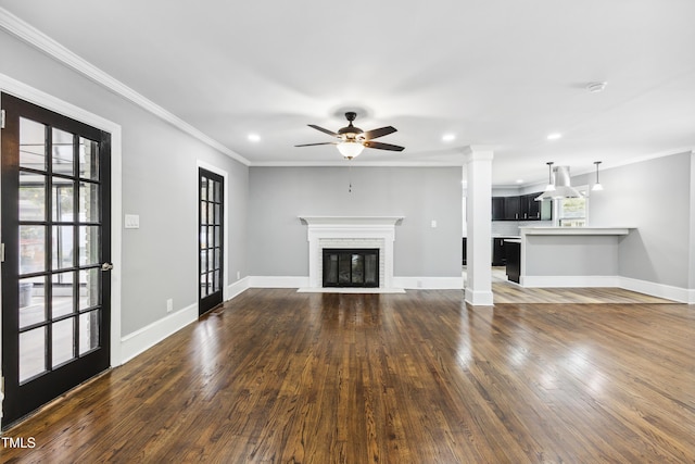 1112 Lakeside Dr NW, Wilson, NC 27896 - unfurnished living room with crown molding, dark wood finished floors, ceiling fan, a brick fireplace, and recessed lighting