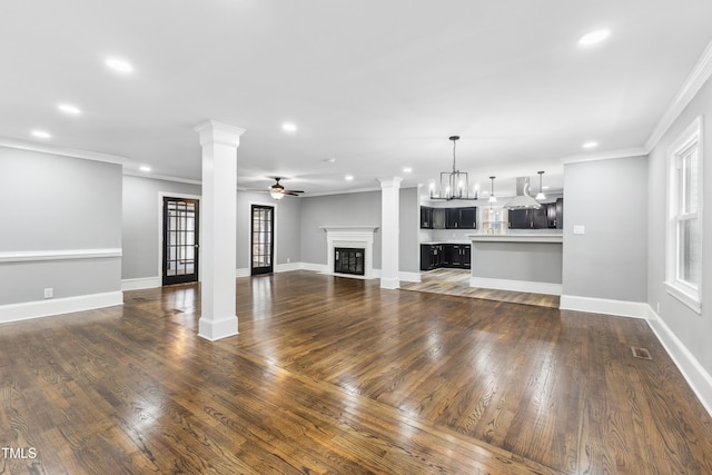 1112 Lakeside Dr NW, Wilson, NC 27896 - unfurnished living room with decorative columns, recessed lighting, crown molding, a ceiling fan, and wood finished floors
