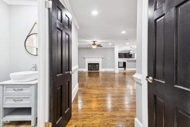 1112 Lakeside Dr NW, Wilson, NC 27896 - hallway featuring ornamental molding, wood finished floors, and recessed lighting