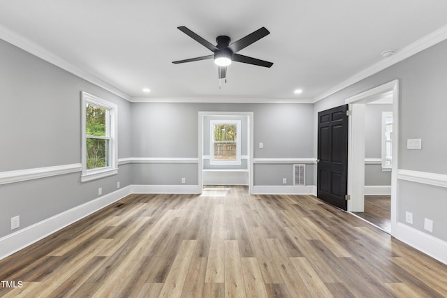 1112 Lakeside Dr NW, Wilson, NC 27896 - unfurnished living room featuring healthy amount of natural light, crown molding, ceiling fan, wood finished floors, and recessed lighting