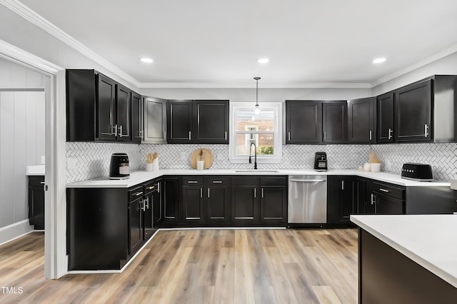 1112 Lakeside Dr NW, Wilson, NC 27896 - kitchen with stainless steel dishwasher, dark cabinetry, light countertops, tasteful backsplash, and crown molding