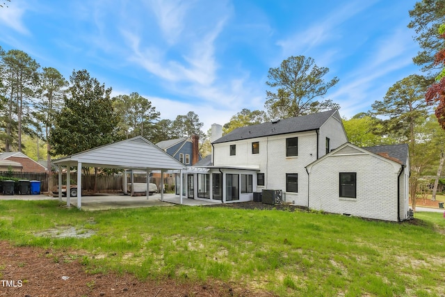 1112 Lakeside Dr NW, Wilson, NC 27896 - rear view of property featuring a sunroom, a patio, and brick siding