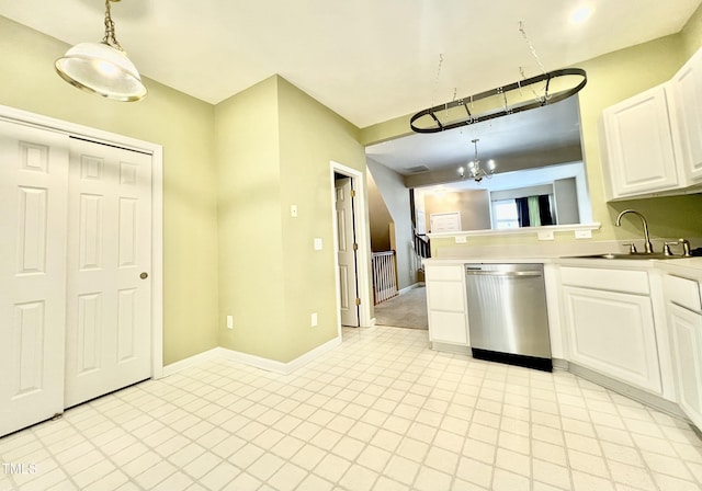 5419 Vista View Ct, Raleigh, NC 27612 - kitchen featuring stainless steel dishwasher, white cabinets, hanging light fixtures, light countertops, and a peninsula