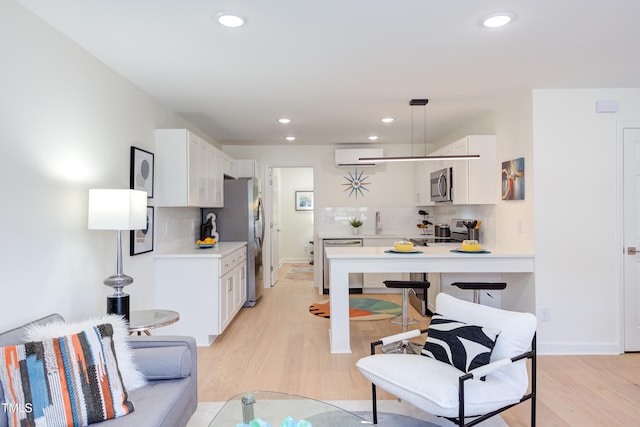 1309 Hudson Ave Unit D6, Durham, NC 27705 - kitchen featuring stainless steel appliances, light wood-style flooring, tasteful backsplash, white cabinetry, and recessed lighting