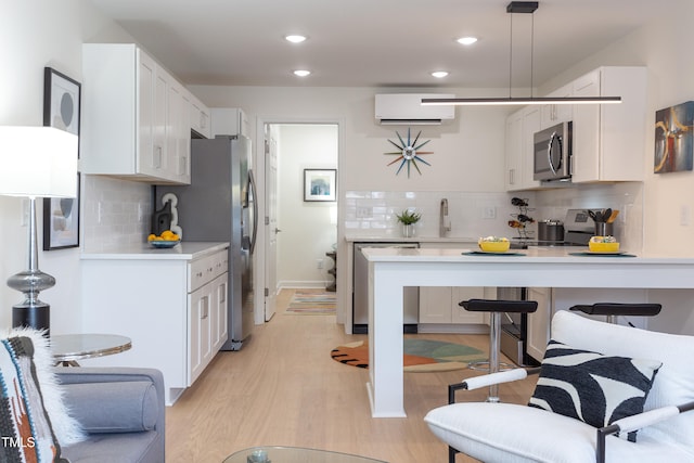 1309 Hudson Ave Unit D6, Durham, NC 27705 - kitchen with stainless steel appliances, a wall unit AC, a peninsula, backsplash, and recessed lighting