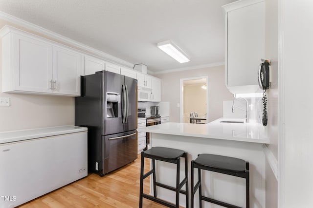 3109 Gold Dust Ln, Willow Springs, NC 27592 - kitchen featuring stainless steel appliances, ornamental molding, white cabinets, a breakfast bar, and light wood-type flooring