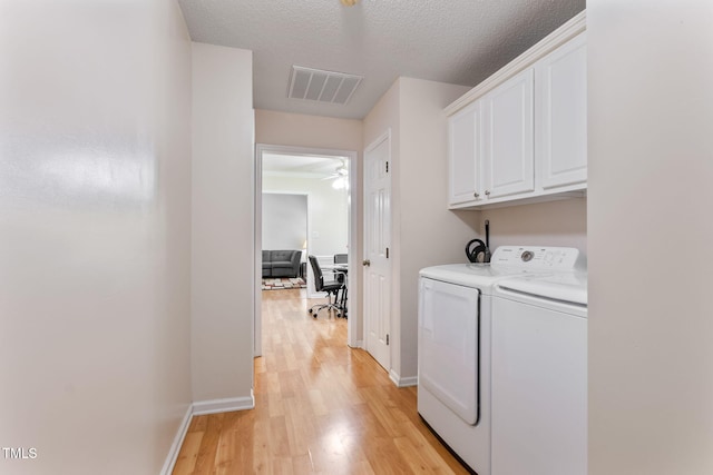 3109 Gold Dust Ln, Willow Springs, NC 27592 - laundry area featuring cabinet space, washing machine and dryer, light wood-style floors, ceiling fan, and a textured ceiling