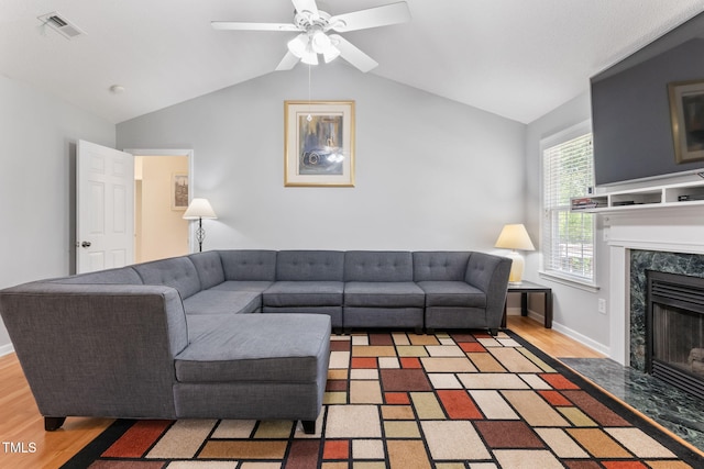 3109 Gold Dust Ln, Willow Springs, NC 27592 - living room featuring wood finished floors, a high end fireplace, ceiling fan, and lofted ceiling