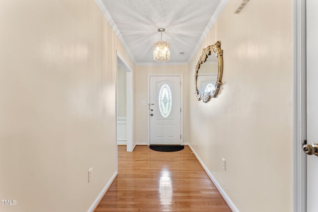 3109 Gold Dust Ln, Willow Springs, NC 27592 - entryway featuring a chandelier, crown molding, and light wood finished floors