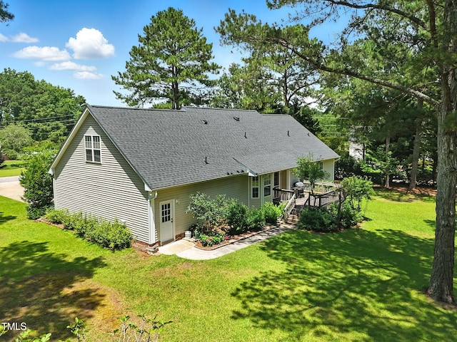 3109 Gold Dust Ln, Willow Springs, NC 27592 - rear view of house with a deck, a shingled roof, and a lawn
