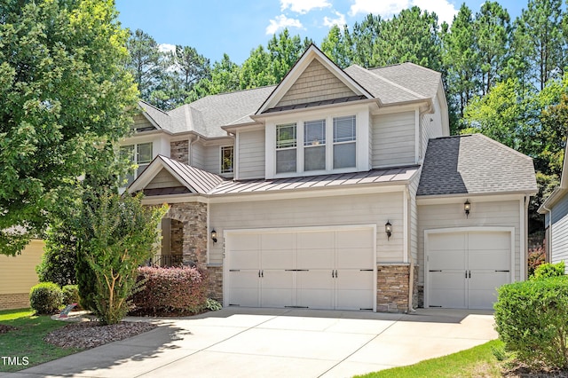 1413 Lily Creek Dr, Cary, NC 27518 - craftsman house featuring a standing seam roof, stone siding, a shingled roof, and driveway